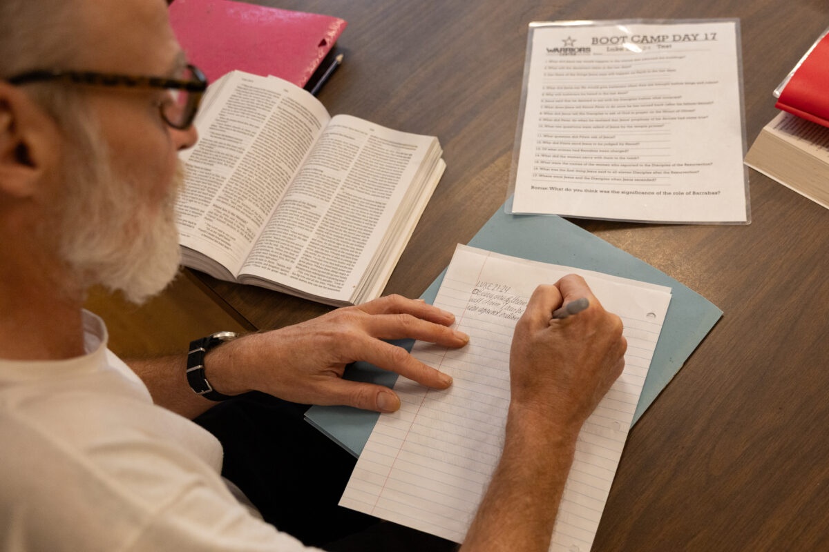 A resident studying with an open Bible during the 28-Day Spiritual Bootcamp