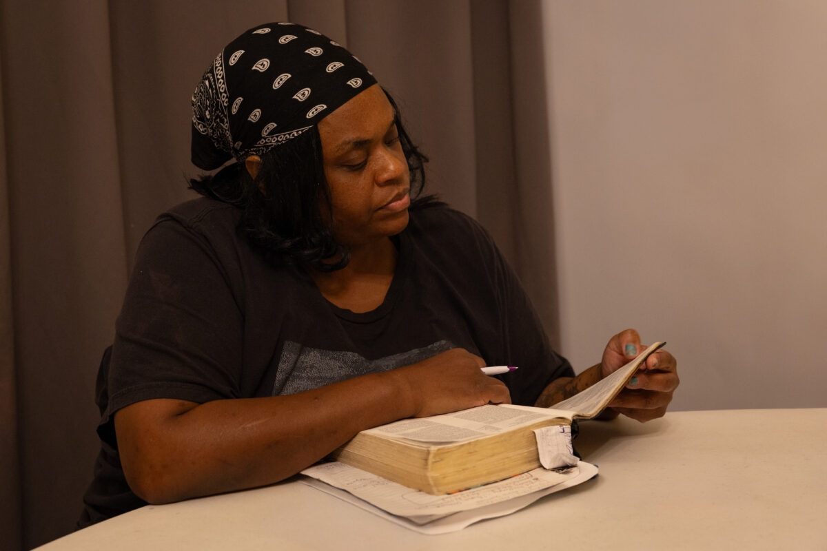 A Warriors Center resident reading her Bible